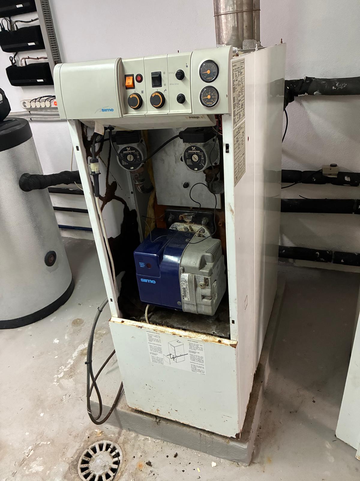 Front view of Sime boiler showing failed Grundfos circulation pumps and blue Sime burner unit