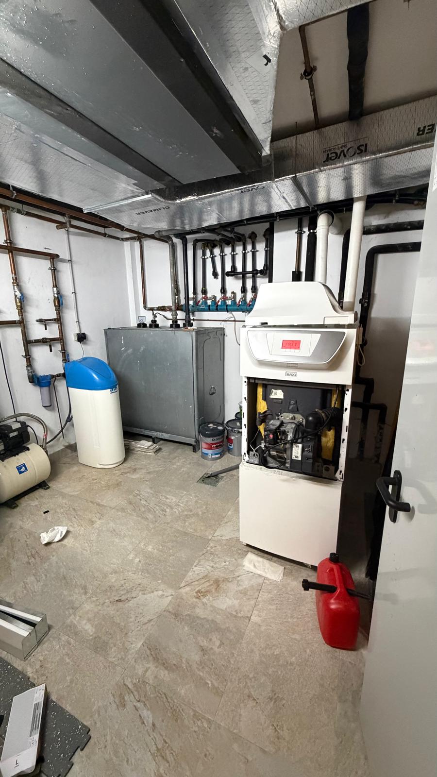 Baxi oil condensing boiler with front panel open showing burner internals — technical assessment before decommissioning in La Cala de Mijas by Agua Therm