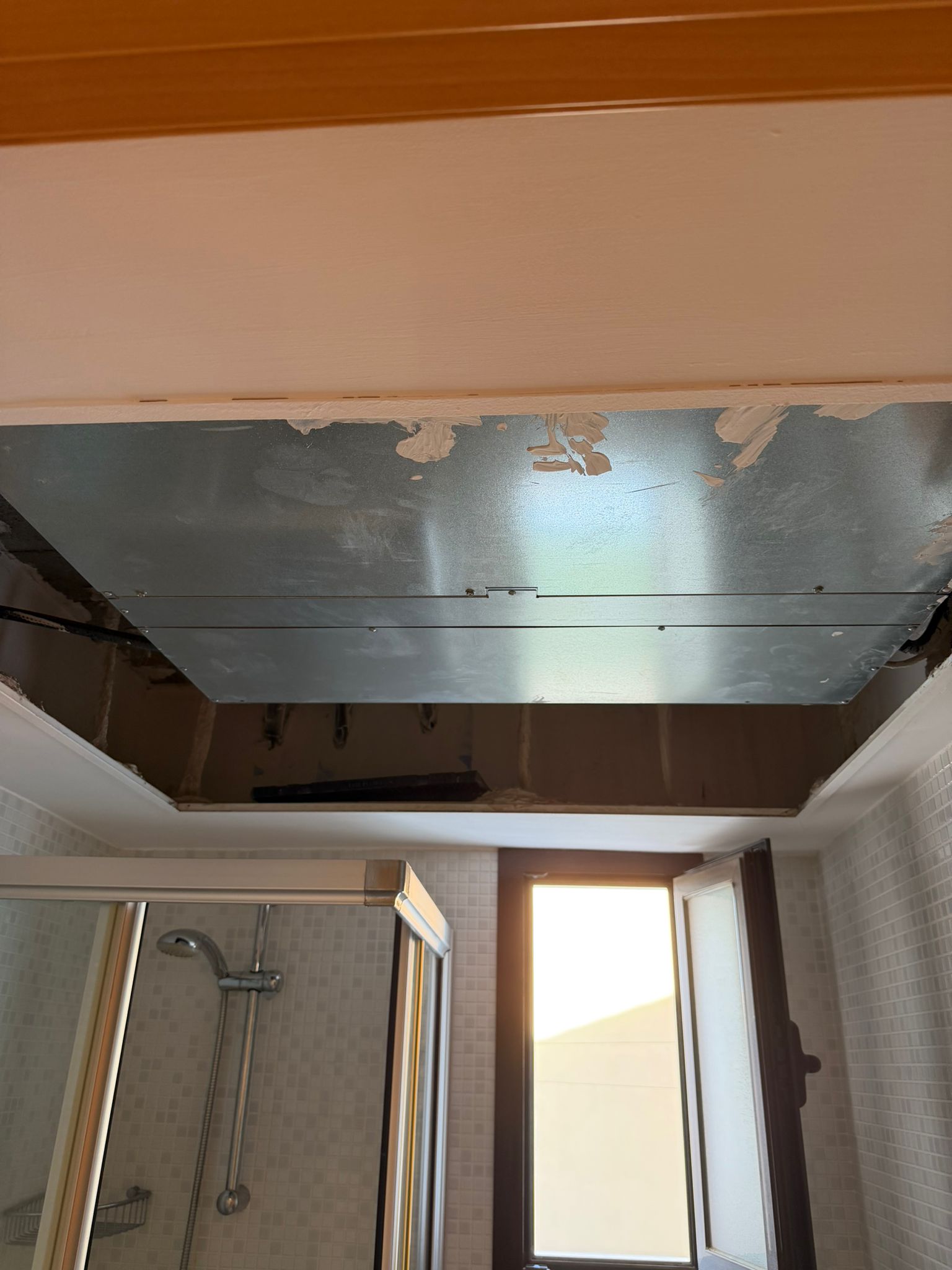 Bathroom false ceiling opened showing existing rigid ductwork in perfect condition