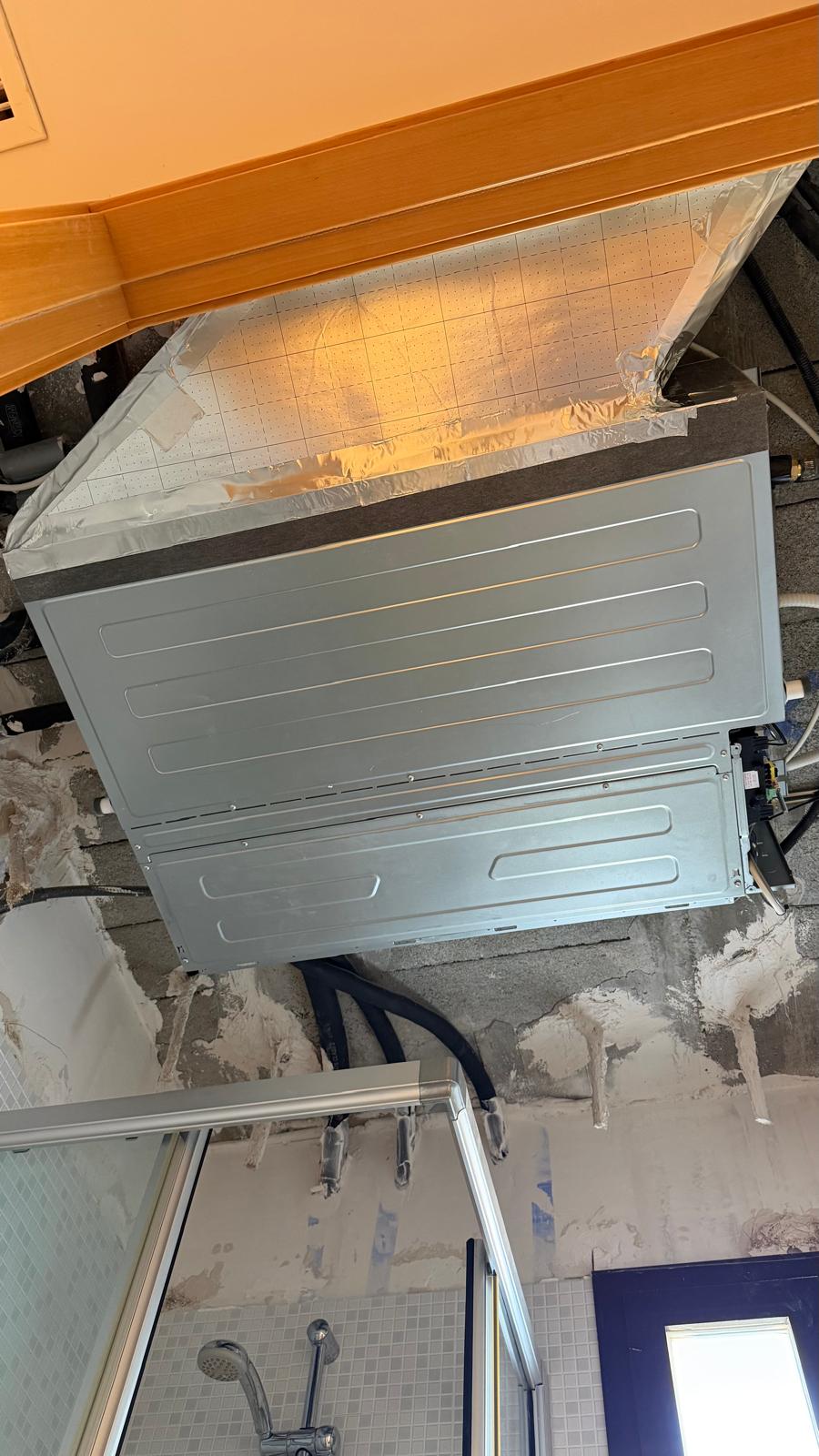 New Johnson concealed ducted indoor unit aligned with existing rigid duct