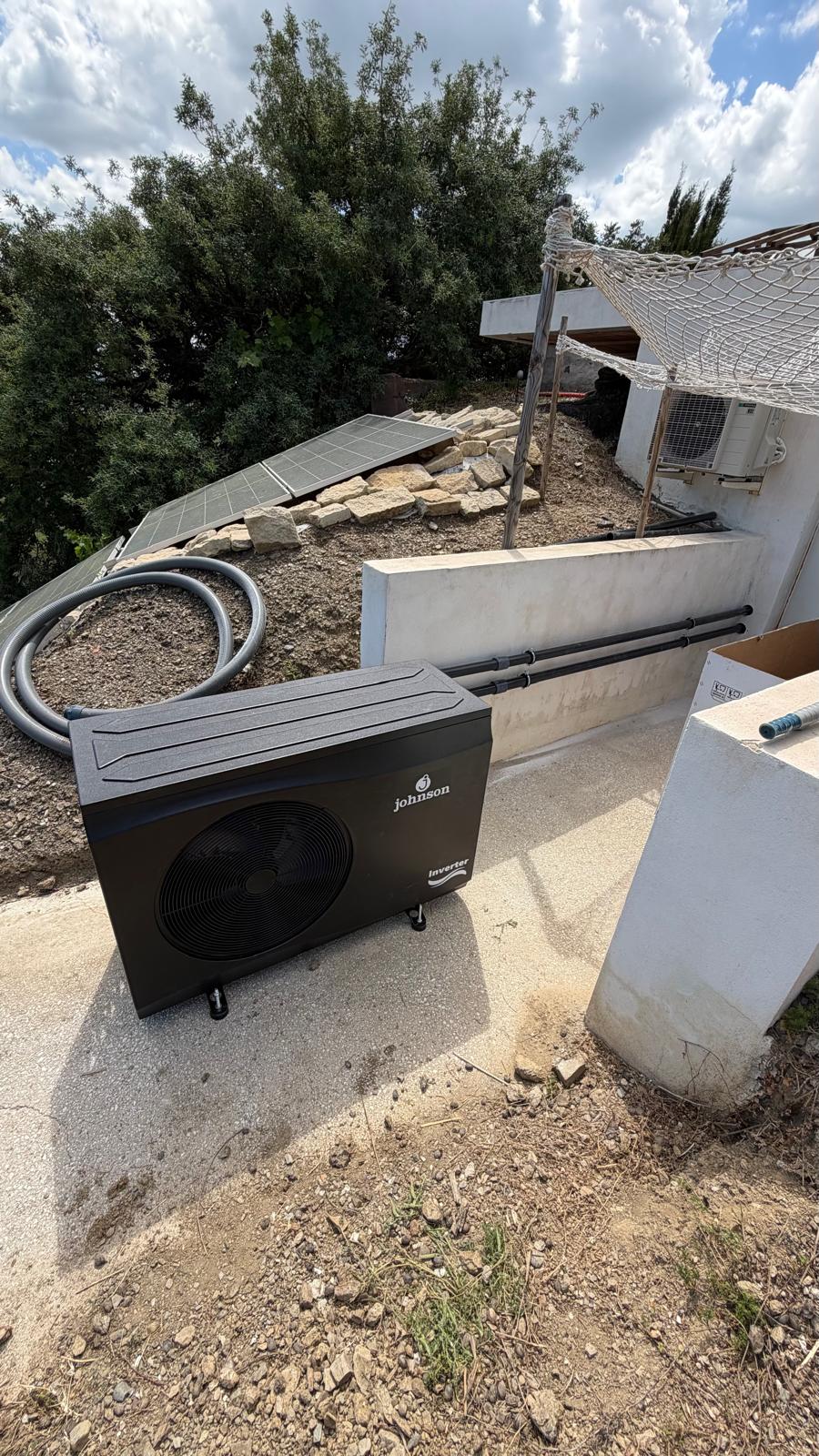 Johnson Inverter unit delivered and positioned next to existing rooftop solar panels and AC condenser