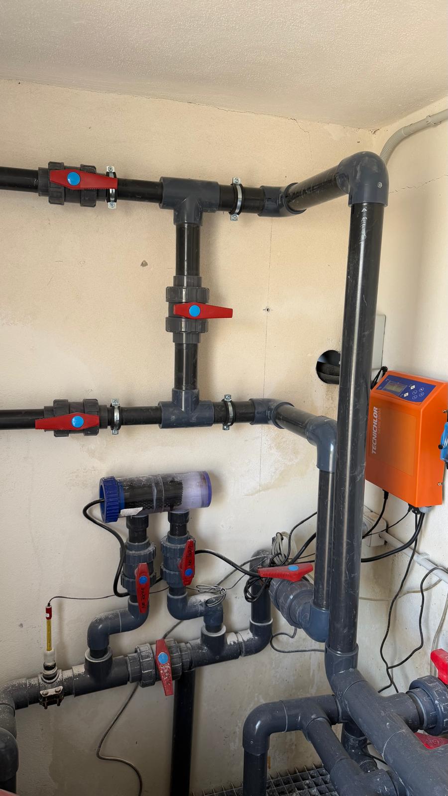 Plant room with Tecniclor salt chlorinator (orange controller) and PVC ball valves