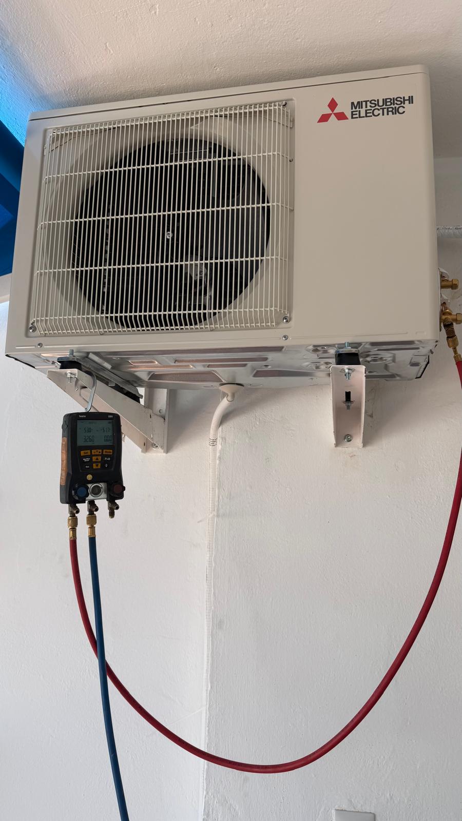 Testo digital manifold gauges connected during R32 refrigerant commissioning of Mitsubishi Electric system