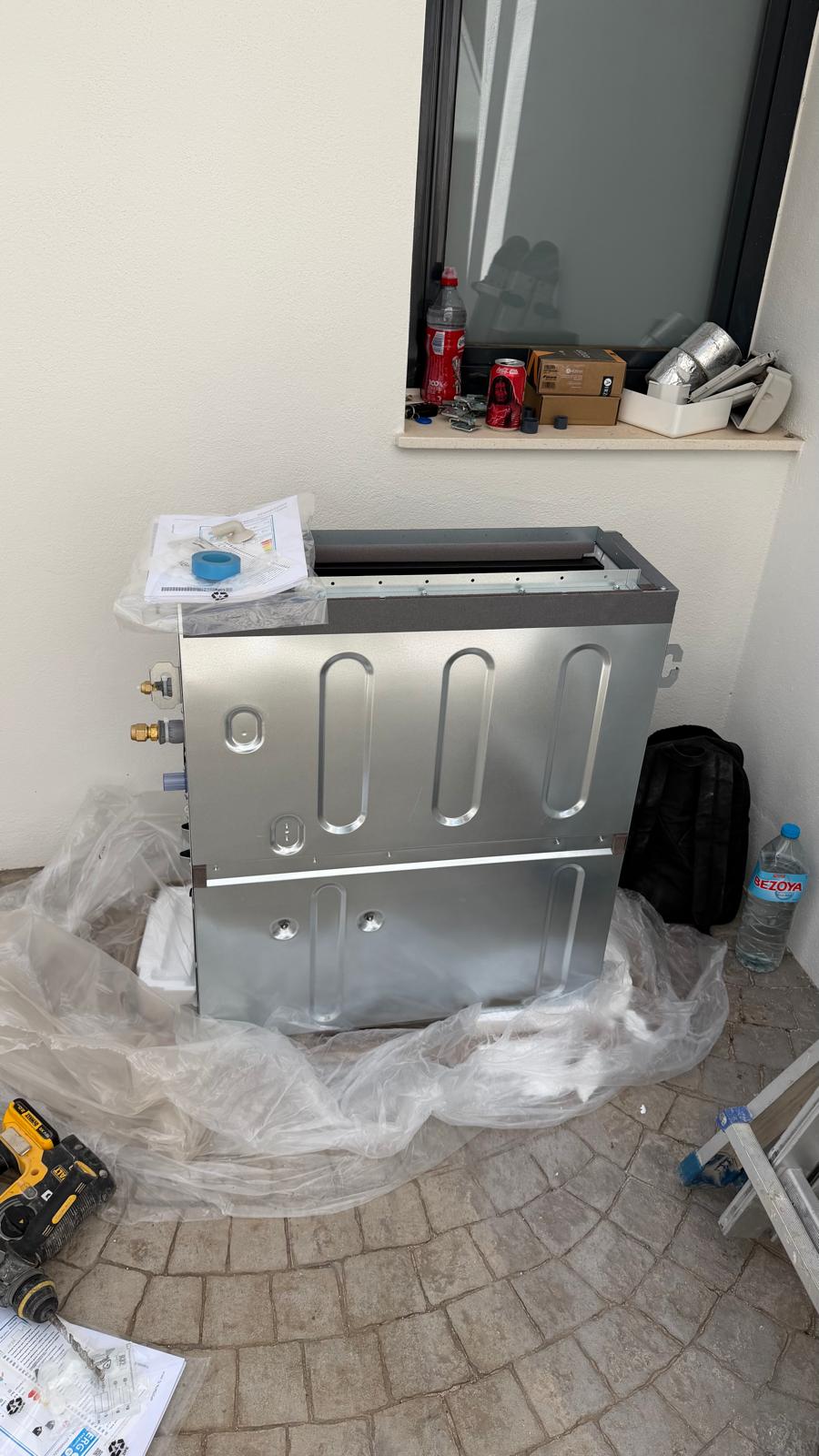 Daikin ADEA50A2VEB indoor unit unboxed on terrace, still in protective polythene wrapping, ready for installation